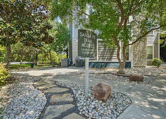 A sign for Santa Fe Trail Access in front of a building.