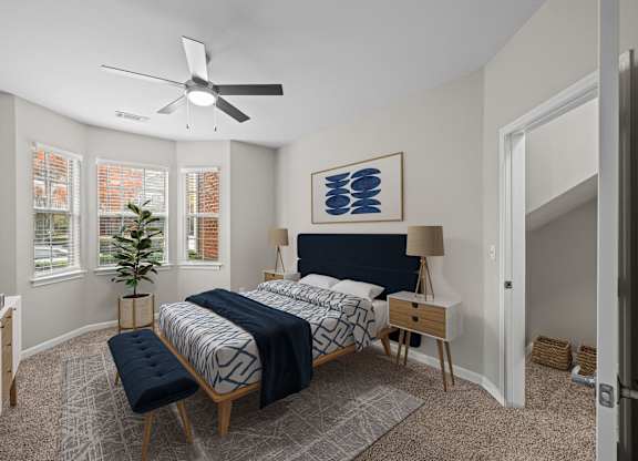 a bedroom with a large bed and a ceiling fan