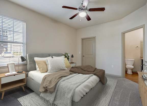 an empty bedroom with a bed and a ceiling fan
