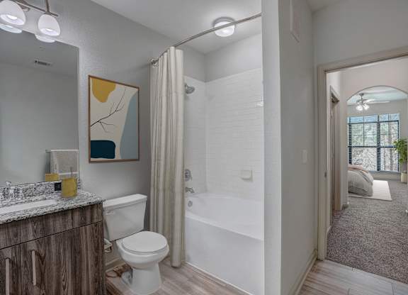 a bathroom with a shower and a toilet and a sink