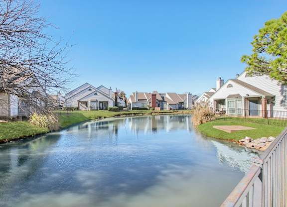 A serene residential area with a canal running through it.