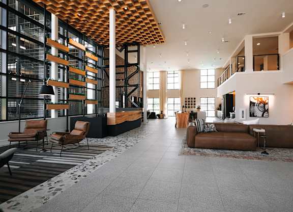 a view of the lobby of a building with couches and chairs
