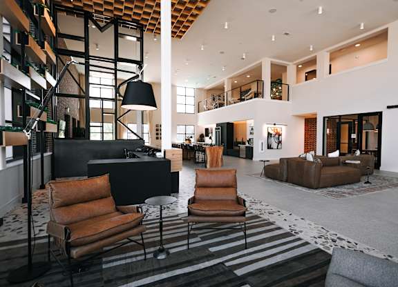 a large lobby with couches and chairs and a fireplace