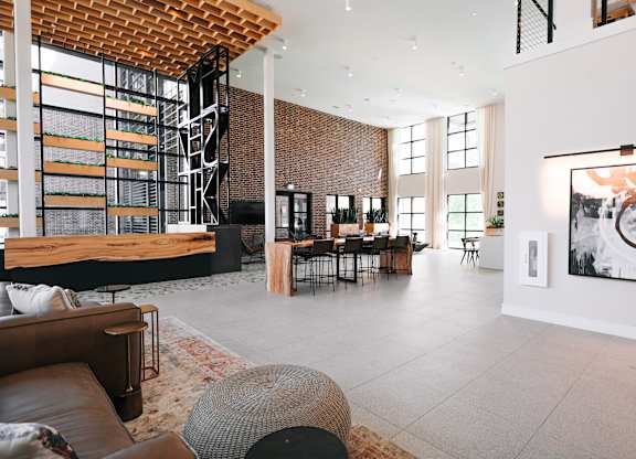 the living room and dining area of a modern house with a large open floor plan