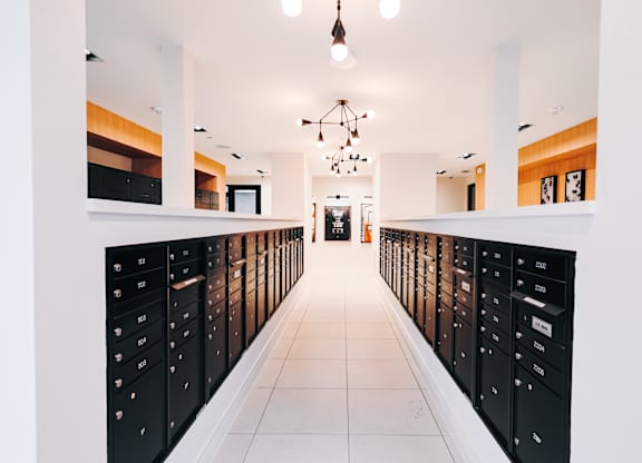 a long corridor with lockers in a room with white ceilings and a white floor