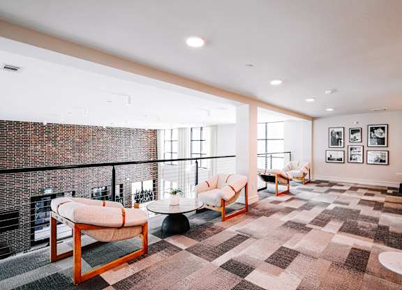 a living room with a brick wall and a balcony