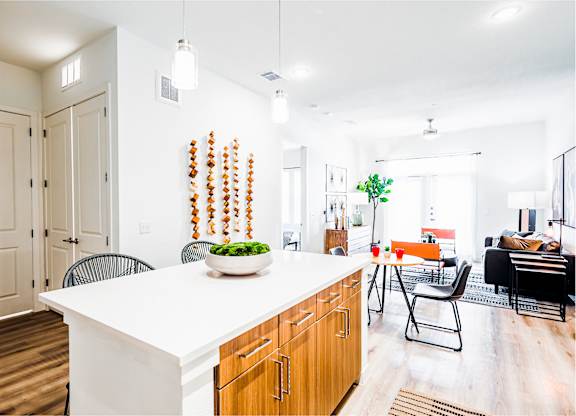 a kitchen with a large island and a living room with a couch