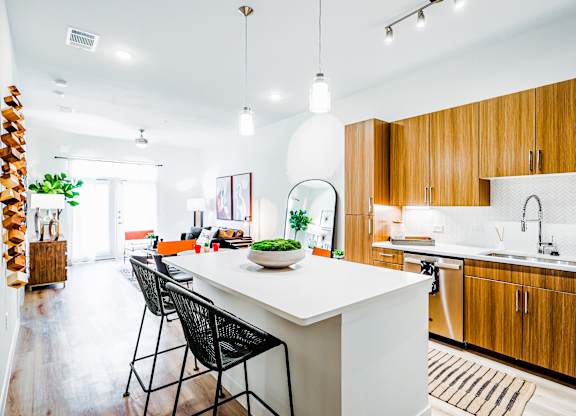 a large kitchen with wooden cabinets and a white counter top