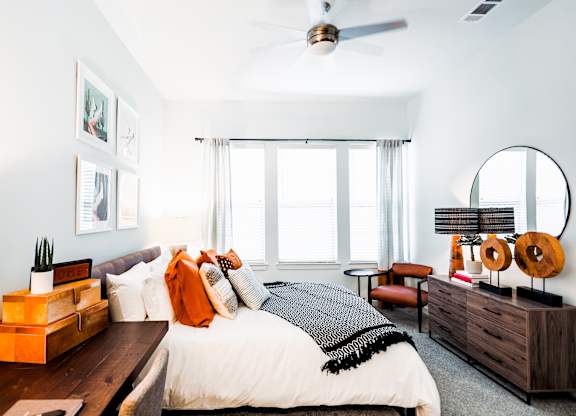 a bedroom with a bed and a large window