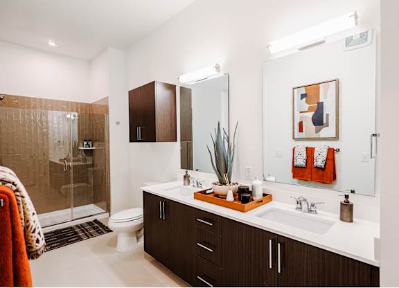 a bathroom with a sink and a shower and a toilet