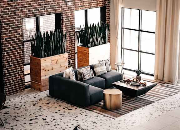 a living room with a black couch and a coffee table