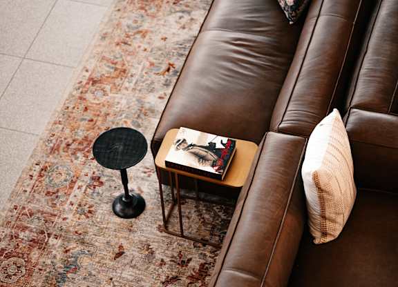 a living room with a couch and a book on a table