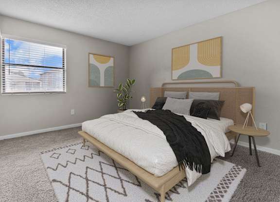 a bedroom with a bed and a window and a rug