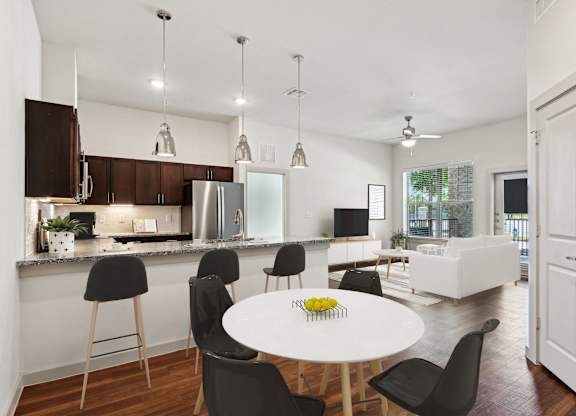 a kitchen and dining room with a white table and chairs