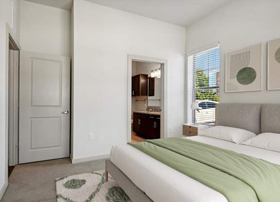 a bedroom with a bed and a door to a bathroom