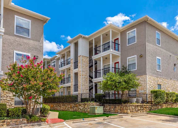 A sunny day at a residential building with a clear blue sky.