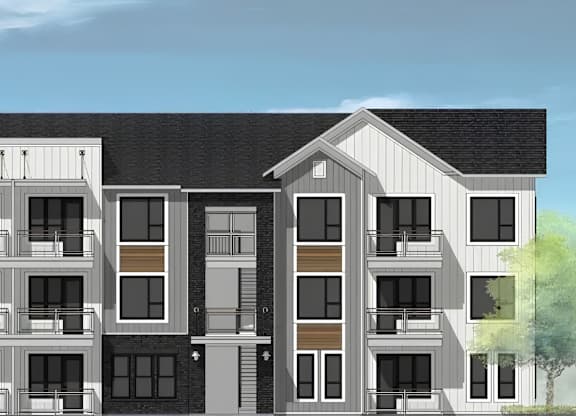A modern apartment building with balconies and a mix of window designs.