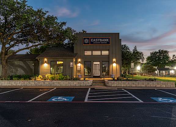 a rendering of the exterior of a building with a parking lot