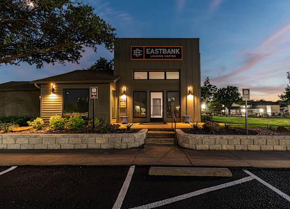 the exterior at night with lights on the building