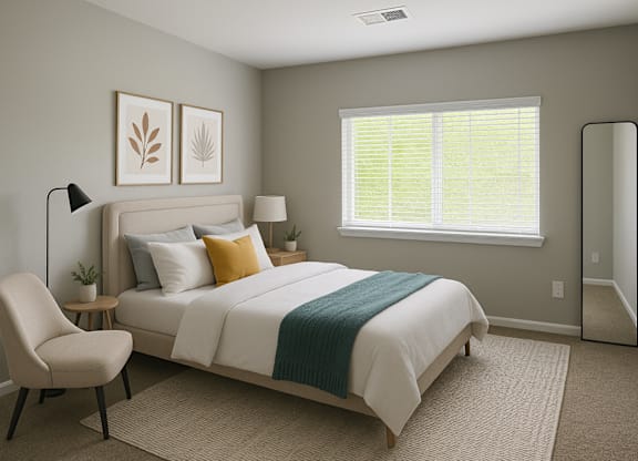A bedroom with a bed, chair, and two framed leaves on the wall.