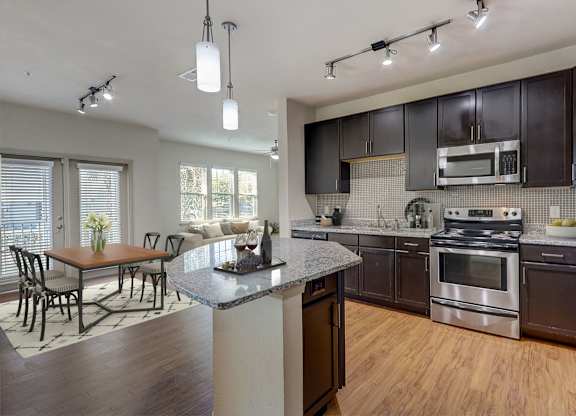 a kitchen with stainless steel appliances and a granite counter top
