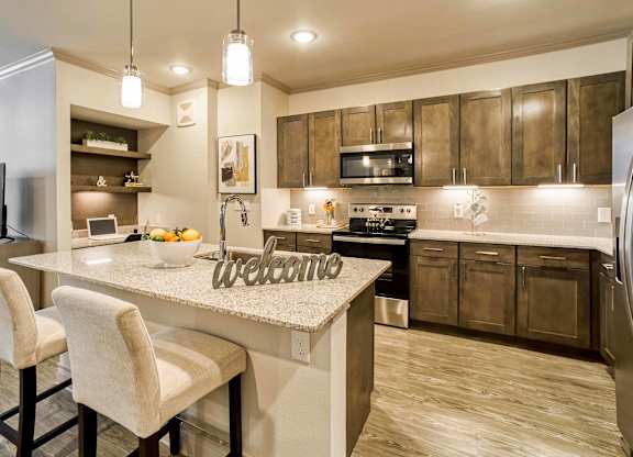 A kitchen with a counter and a sign that says