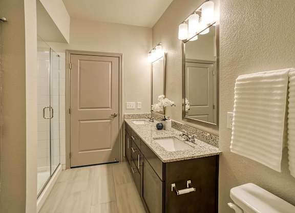 A bathroom with a sink, mirror, and toilet.