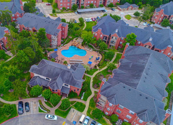 an aerial view of a neighborhood with a swimming pool and parking lot