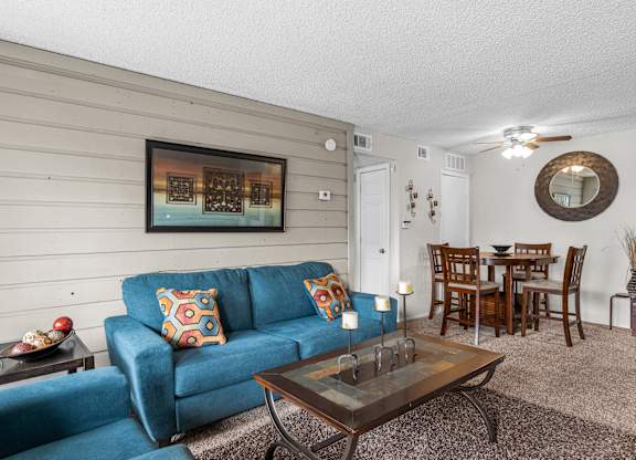 a living room with a blue couch and a coffee table
