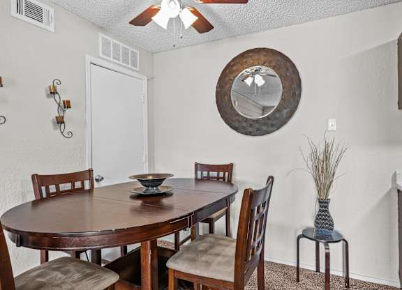a dining room with a table and chairs