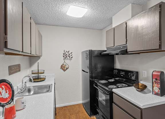 a kitchen with a stove top oven next to a sink