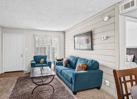 a living room with a blue couch and a coffee table