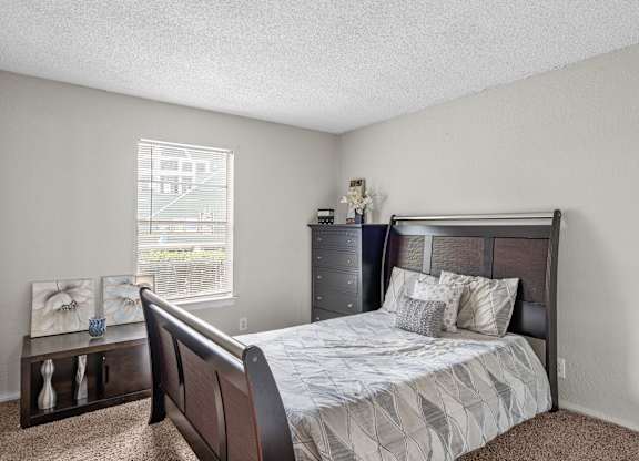 a bedroom with a bed and a dresser