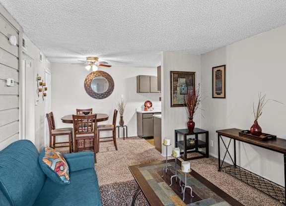 a living room with a couch a table and a ceiling fan