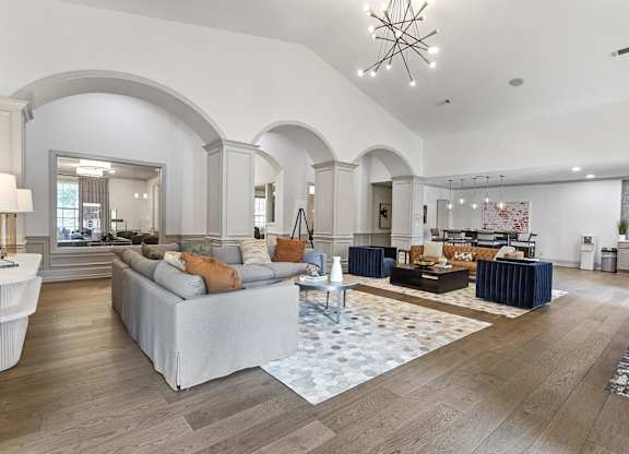 a living room with couches and a rug