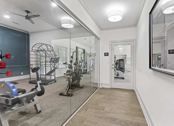 the gym in the owners home is equipped with a treadmill and weights