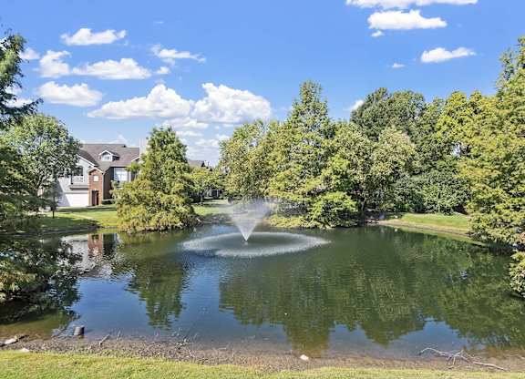 a fountain in the middle of a pond