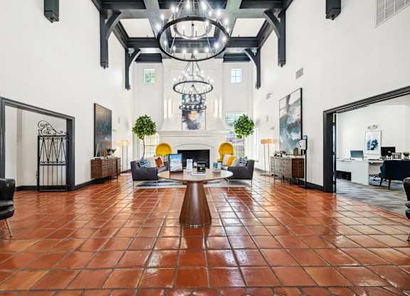 a large living room with a fireplace and a large chandelier