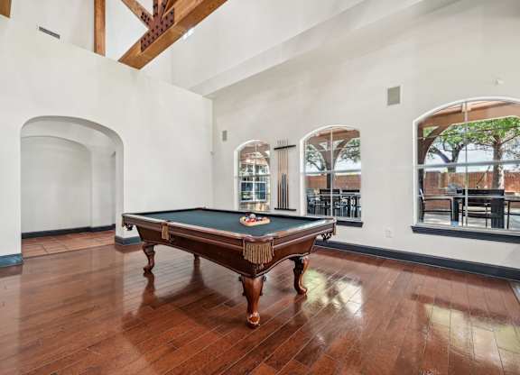 a room with a pool table in the middle of it