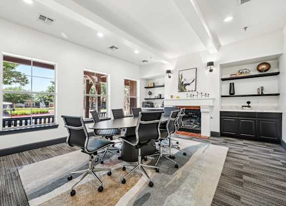 a conference room with a table and chairs and a fireplace