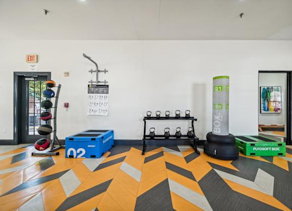 a fitness room with weights and other gym equipment