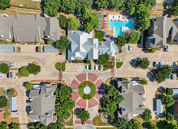 an aerial view of a neighborhood with houses and trees