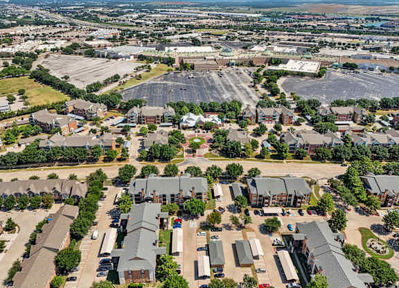 an aerial view of a suburb of a city with a large parking lot