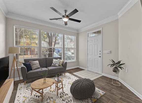 a living room with a couch and a ceiling fan