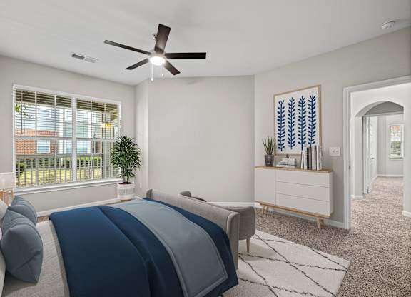 a bedroom with a bed and a ceiling fan