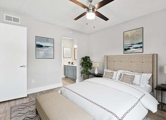 a bedroom with a bed and a ceiling fan