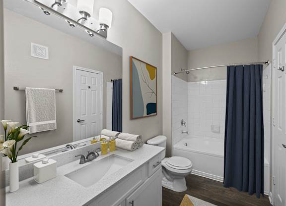 a bathroom with a shower and a sink and a toilet