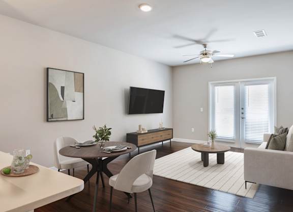 A modern living room with a dining table and chairs.