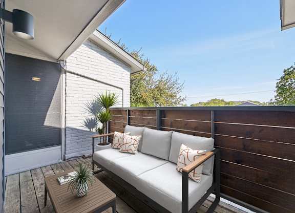 a balcony with a couch and a table