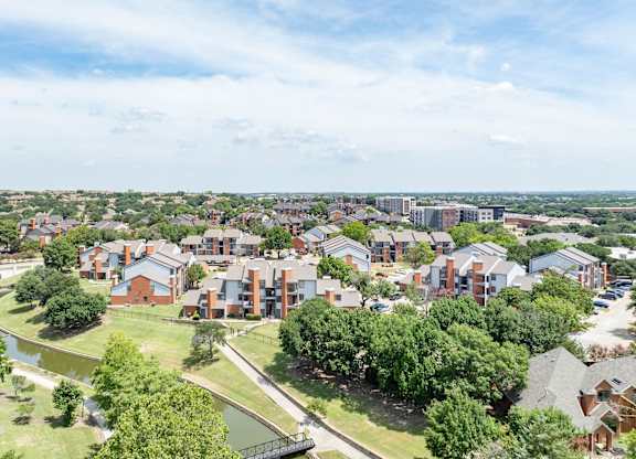 Aerial view of Heritage at Valley Ranch with pond, walking paths, and surrounding Irving neighborhood.